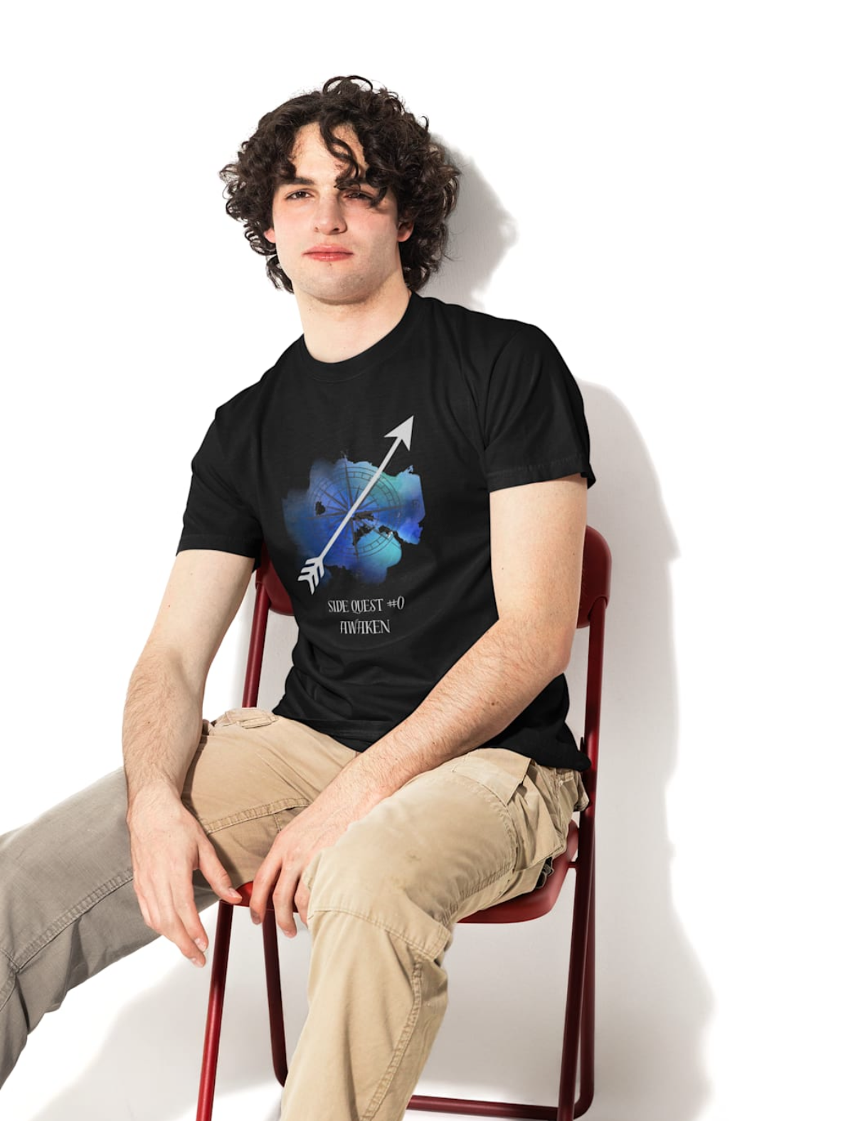 Person sitting on a chair wearing a black t-shirt with a graphic design.